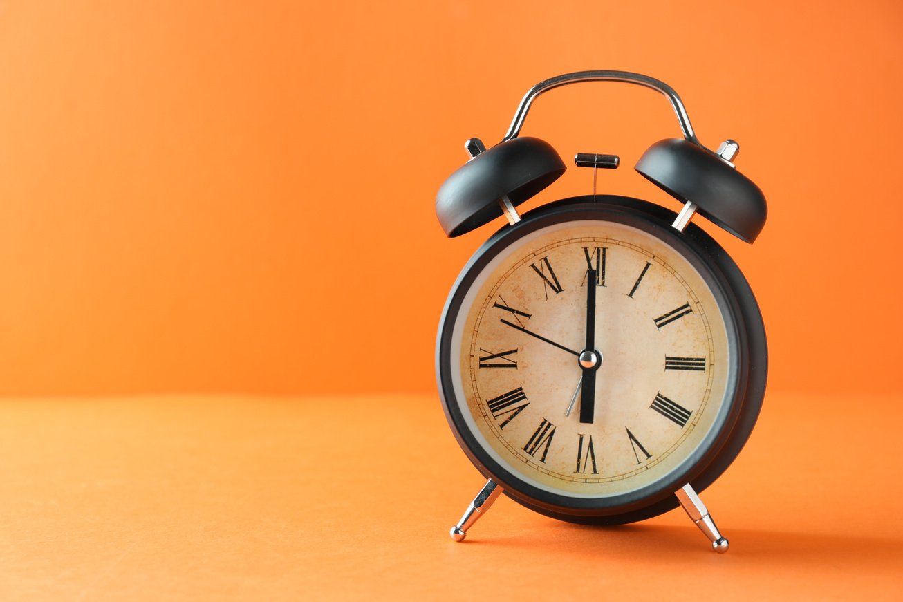 Alarm Clock on Orange Background